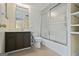 A clean bathroom with tile floors, a vanity, a toilet, and a glass-enclosed shower-tub combination at 5493 Alexanders Lake Sw Rd, Stockbridge, GA 30281