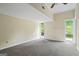 A serene bedroom with high ceilings, carpet, and windows bringing in natural light, creating an inviting space at 5493 Alexanders Lake Sw Rd, Stockbridge, GA 30281