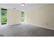 Bedroom with carpet and windows looking out to green scenery at 5493 Alexanders Lake Sw Rd, Stockbridge, GA 30281