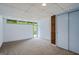 Bright, carpeted bedroom with natural light through windows, complemented by a closet for ample storage at 5493 Alexanders Lake Sw Rd, Stockbridge, GA 30281