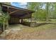 Wood beam carport with room for vehicles and equipment, offering covered storage and functionality on the property at 5493 Alexanders Lake Sw Rd, Stockbridge, GA 30281