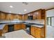 Traditional style kitchen with wood cabinets, black appliances, and durable countertops, ready for any home chef at 5493 Alexanders Lake Sw Rd, Stockbridge, GA 30281