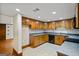 A bright kitchen features tiled floor, wood cabinets, black appliances, and ample counter space for cooking and entertaining at 5493 Alexanders Lake Sw Rd, Stockbridge, GA 30281