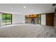 Bright and airy living room with plush gray carpet, a stone fireplace, and a sliding glass door to the backyard at 5493 Alexanders Lake Sw Rd, Stockbridge, GA 30281