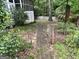 Charming backyard features a brick pathway, green lawn, and a picket fence with a gate at 332 Wyngate Rd, Auburn, GA 30011