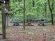 Backyard fire pit area with two chairs and a partial view of an outbuilding at 332 Wyngate Rd, Auburn, GA 30011