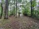 View of the back of the house and a picnic table from the yard; treed area at 332 Wyngate Rd, Auburn, GA 30011