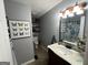 Bathroom featuring a decorative butterfly print, ornate vanity, and modern lighting at 332 Wyngate Rd, Auburn, GA 30011