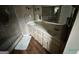 Large bathroom features a tiled shower, neutral vanity, and an oversized mirror at 332 Wyngate Rd, Auburn, GA 30011