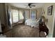 Well-lit bedroom with a ceiling fan, plush carpet, and comfortable bed at 332 Wyngate Rd, Auburn, GA 30011