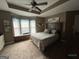 Spacious bedroom with a tray ceiling, ceiling fan, and a window seat at 332 Wyngate Rd, Auburn, GA 30011