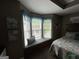 A serene bedroom features a cozy window seat beneath a bay window for relaxation at 332 Wyngate Rd, Auburn, GA 30011