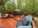 Spacious deck featuring a blue umbrella, comfortable seating, and wood railings, great for entertaining at 332 Wyngate Rd, Auburn, GA 30011