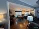 View of dining area with wood floors and a kitchen with white cabinets at 332 Wyngate Rd, Auburn, GA 30011