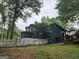 Back of a lovely blue house featuring a screened porch, deck and white picket fence at 332 Wyngate Rd, Auburn, GA 30011