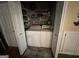 Convenient laundry room featuring washer, dryer, and shelving for storage solutions at 332 Wyngate Rd, Auburn, GA 30011