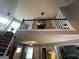 Second story loft and stairwell featuring a rail and a view to the entryway below at 332 Wyngate Rd, Auburn, GA 30011