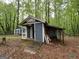 View of two exterior buildings on a wooded property at 332 Wyngate Rd, Auburn, GA 30011