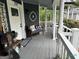 Welcoming front porch with comfortable bench seating and decorative cushions at 332 Wyngate Rd, Auburn, GA 30011