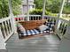 Cozy porch swing with comfortable cushions, perfect for relaxation and enjoying the outdoors at 332 Wyngate Rd, Auburn, GA 30011
