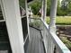Inviting porch with white railings and an American flag, offering a serene outdoor space at 332 Wyngate Rd, Auburn, GA 30011