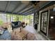 Inviting screened porch with comfortable seating and views of the landscaped backyard at 332 Wyngate Rd, Auburn, GA 30011