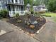 Beautifully landscaped front yard with garden beds and charming decorations at 332 Wyngate Rd, Auburn, GA 30011