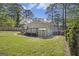 Well-maintained backyard with a deck, storage shed, lush green lawn, and mature trees at 1858 Ridgeland Dr, Decatur, GA 30032