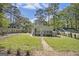 Spacious backyard featuring a well-maintained lawn, a deck, mature trees, and a storage shed at 1858 Ridgeland Dr, Decatur, GA 30032