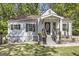 Charming one-story home featuring white siding, brown shutters, and a welcoming front porch at 1858 Ridgeland Dr, Decatur, GA 30032