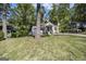 A beautiful one-story home stands on a lush green lawn with mature trees at 1858 Ridgeland Dr, Decatur, GA 30032
