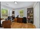 Bright home office with hardwood floors, built-in bookshelves, natural light from multiple windows, and a desk space at 1858 Ridgeland Dr, Decatur, GA 30032