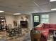 Finished basement with tile floors, shelving, dining table, and sectional sofa at 160 Hialeah Way, Roswell, GA 30075
