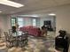 Finished basement with tile floors, seating area, dining table, and tv at 160 Hialeah Way, Roswell, GA 30075
