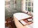 Bright, open bathroom with soaking tub, marble shower, and a stool for books or towels at 160 Hialeah Way, Roswell, GA 30075