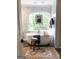 Luxurious soaking tub by large window in bathroom featuring marble walls and wood look tile at 160 Hialeah Way, Roswell, GA 30075