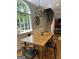 Dining room features a rustic table, modern chairs, and a large window for natural light at 160 Hialeah Way, Roswell, GA 30075