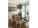 Dining room with hardwood floors, round table, stylish light fixture, and patterned curtains at 160 Hialeah Way, Roswell, GA 30075