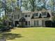 Stately painted brick home with manicured lawn and lush landscaping at 160 Hialeah Way, Roswell, GA 30075