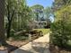 Charming painted brick home with a long driveway and mature trees at 160 Hialeah Way, Roswell, GA 30075