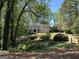 Elegant painted brick home with a long driveway surrounded by trees at 160 Hialeah Way, Roswell, GA 30075