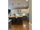 Kitchen island with white cabinets, wooden countertop, pendant lights, and barstool seating at 160 Hialeah Way, Roswell, GA 30075