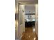 Hallway view of a modern kitchen with a center island and bar stool seating at 160 Hialeah Way, Roswell, GA 30075