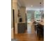 Open kitchen with hardwood floors, breakfast bar, stainless appliances, and access to a rear deck at 160 Hialeah Way, Roswell, GA 30075
