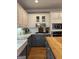 Kitchen with white and blue cabinets, hardwood floors, and stainless steel appliances at 160 Hialeah Way, Roswell, GA 30075