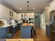 Bright kitchen with custom cabinets, center island, stainless appliances, and hardwood floors at 160 Hialeah Way, Roswell, GA 30075