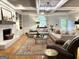 Elegant living room with coffered ceiling, fireplace, and views to the outdoor garden at 160 Hialeah Way, Roswell, GA 30075