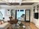 Open living room with coffered ceiling, hardwood floors, built-in bookshelves, fireplace and stylish furniture at 160 Hialeah Way, Roswell, GA 30075