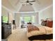 Bright and airy bedroom with a bay window, tray ceiling, carpet and a ceiling fan at 160 Hialeah Way, Roswell, GA 30075
