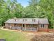 Aerial view showcases this beautiful single Gathering home, nestled among mature trees on a spacious lot at 930 Singley Dr, Locust Grove, GA 30248